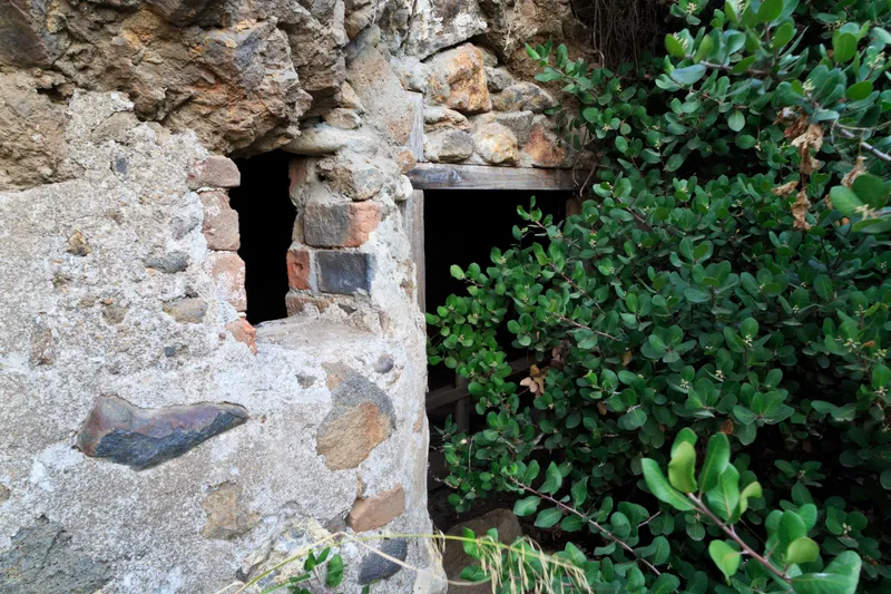 opening in cliff face that has been converted into dairy cave with door